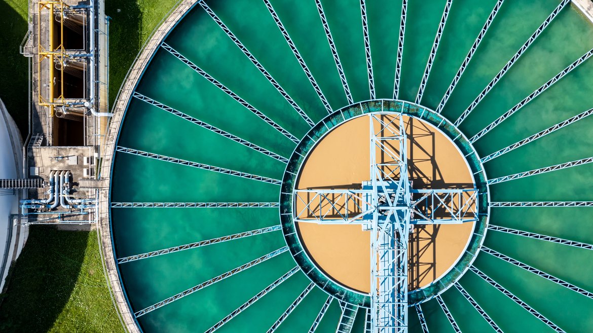 Aerial view of purification tanks of wastewater treatment plant. © Shutterstock